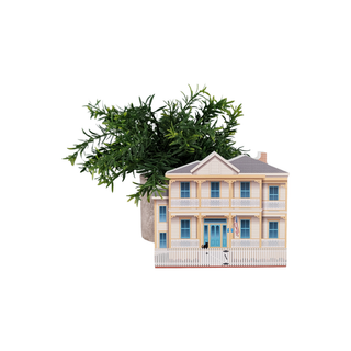 Model of a two-story house with decorative greenery on top against a white background