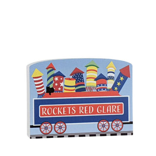 3/4" Wooden replica with a train car with colorful rocket designs and 'Rockets Red Glare' text on a white background