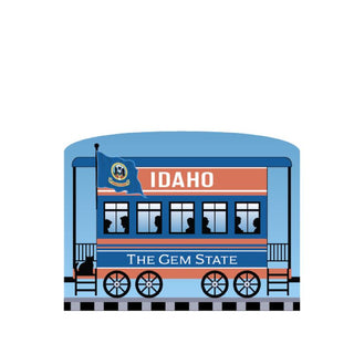 3/4" Wooden replica with a Illustration of a train car with Idaho-themed design on a white background