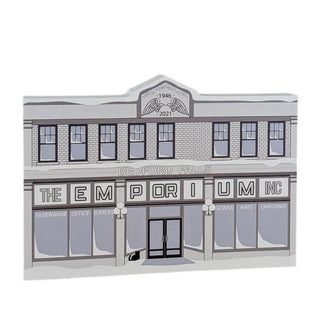 3/4" thick wooden replica with an illustration of a  store front with 'The Emporium' sign and 'Bedford Falls' text on a white background