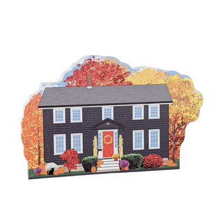 3/4" thick wooden model of a house with autumn trees in the background