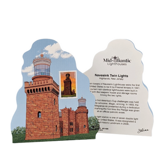 A Mid-Atlantic Lighthouses commemorative plaque featuring Navesink Twin Lights in Highlands, New Jersey. The white and blue plaque includes an illustration of the twin lighthouses, a postage stamp design, and text detailing the lighthouse history.