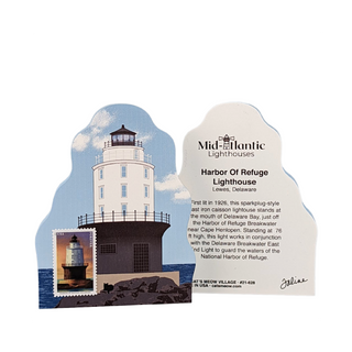 A decorative lighthouse-shaped plaque featuring an illustration of the Harbor Of Refuge Lighthouse in Lewes, Delaware, with a small postage stamp inset and a printed informational card beside it. The card shows the Mid-Atlantic Lighthouses branding and the lighthouse name and location.
