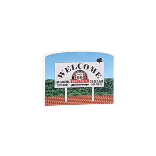 3/4" thick wood Welcome sign for Route 66 with a blue sky and green landscape in the background.