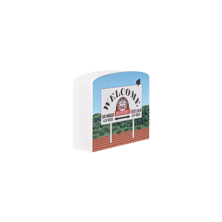 3/4" thick wood Welcome sign for Route 66 with a blue sky and green landscape in the background.