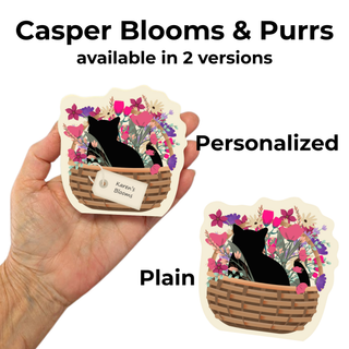 Hand holding a 3/4" thick wooden cutout with a black cat in a basket surrounded by flowers, labeled 'Casper Blooms & Purrs' with two versions shown.