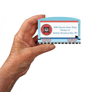  Hand holding a 3/4" Wooden replica with a with a design and text on a white background