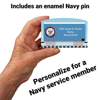 Hand holding a 3/4" Wooden replica with a  with a navy design, text about a personalized enamel navy pin for a service member.