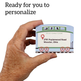 3/4" Wooden replica with a Hand holding a personalized address label with text '2791 Poplarwood Road Wooster, Ohio' on a white background.