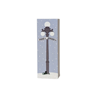 3/4" thick wooden replica with an illustration with a street lamp and 'Genesee St Jefferson Ave' sign on a snowy background.
