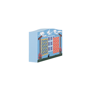 3/4" thick wooden illustration of quilts hanging on a clothesline against a blue sky.