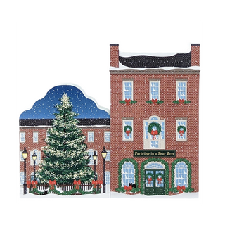 3/4" thick wooden Christmas-themed scene with a decorated tree and brick building featuring festive window displays.