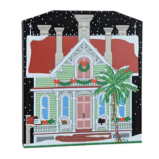 3/4" thick wooden replica with an illustration of a  house with Christmas decorations on a black background
