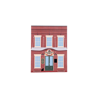 3/4" wooden replica with an illustration of a red brick building with a sign on a white background