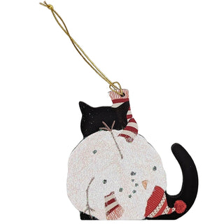 wooden ornament with a black cat and a crumpled up snowman with red had 