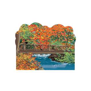 3/4" thick wooden Wooden bridge over a river with autumn trees on either side