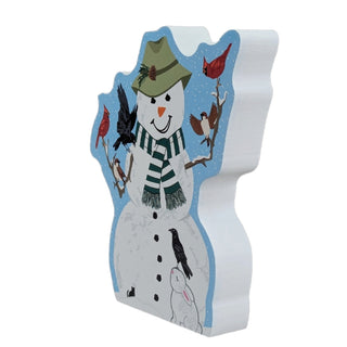 3/4" thick wooden replica with an Illustration of  a white snowman with a green striped scarf, green hat, black buttons, birds perched on branches, and a small white bunny on a light blue snowy background.