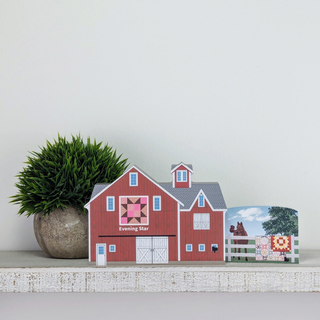 3/4" thick wooden illustration of a red barn with quilt design on a display shelf 