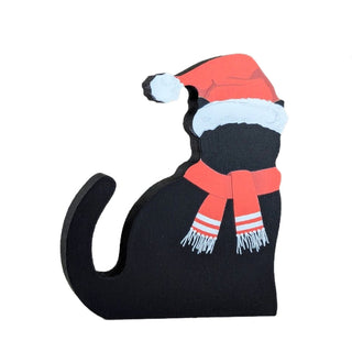 3/4" thick wooden replica of a black cat dressed up as santa clause 