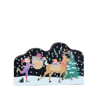 3/4" thick wooden replica with an illustration of a  reindeer and a fairy with a basket in a snowy scene