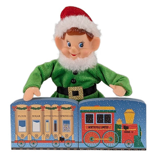 elf on the shelf holding two wooden replicas of christmas themed train cars