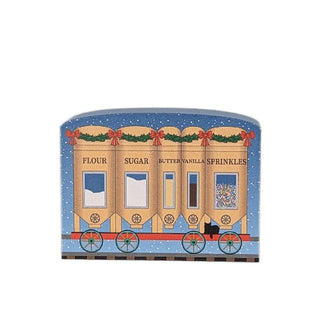 3/4" thick wooden replica with an illustration of a  toy train with labeled cargo cars on a snowy background