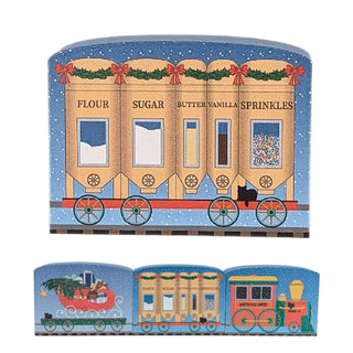 3/4" thick wooden replica with an illustration of a christmas themed train car with baking ingredient dispensers 