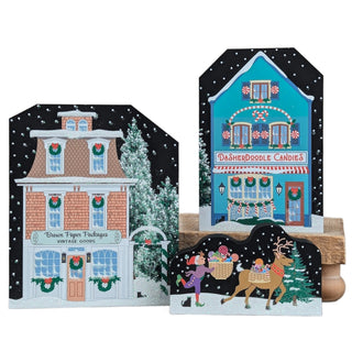 Two Christmas-themed house-shaped cards with festive designs on a white background.