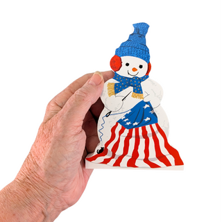 hand holding 3/4" thick wooden snowman sewing american flag on white background