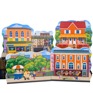 Illustrated city scene with colorful 3/4" thick wooden buildings and people on a white background