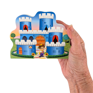 Hand holding 3/4" thick Wooden replica of Daniel Tiger's Neighborhood, Royal Castle handcrafted by The Cat's Meow Village in the USA. Licensed by Fred Rogers Productions & PBS Kids.