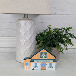3/4" thick wooden illustration of a model of a building with 'Lucky's Shamrock Inn' sign on a display table