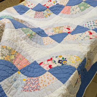 Patchwork quilt with floral patterns on a surface