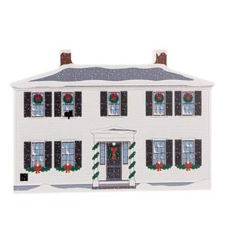 wooden replica with an illustration of a white house ornament with festive christmas window decorations on a white background
