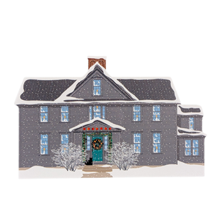 wooden replica with an illustration of a gray house with a snowy landscape on a white background