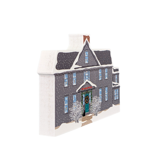 wooden replica with an illustration of a gray house with a snowy landscape on a white background