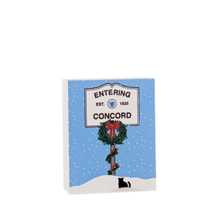 wooden replica with an illustration of a sign that says 'entering concord' and wreath design on a white background