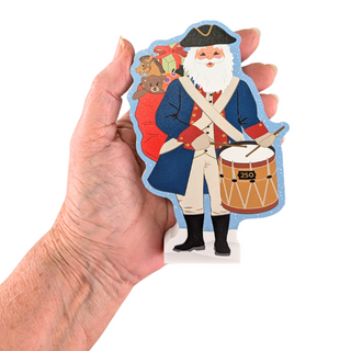 hand holding 3/4" thick wooden santa representing America 250 on white background
