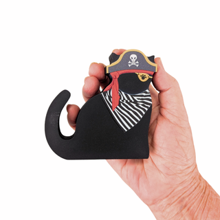 Hand holding a 3/4" thick wooden black pirate-themed black cat against a white background