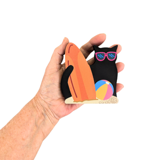 Hand holding a 3/4" wooden replica with a cat design, and beach ball.