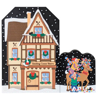 3/4" thick wooden replica with an illustration of a Christmas-themed house with decorative elements and a reindeer scene on a snowy background.