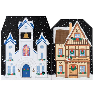 Two festive Christmas-themed houses with decorative elements on a snowy background.