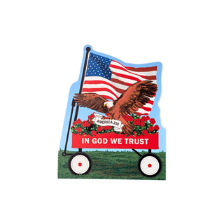 3/4" thick wooden replica with an illustration of an American flag, a brown eagle, red flowers, and the text 'IN GOD WE TRUST' on a red banner above a cart, shown on a plain white background.