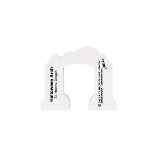 A white Halloween arch sign with black printed text reading 'Halloween Arch St. Helens, Oregon' and copyright details for Jim Shaw, shown on a plain white background.