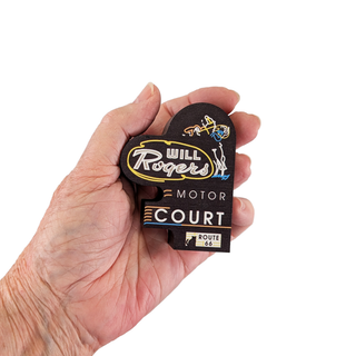Hand holding a 3/4" thick decorative sign with 'Will Rogers Motor Court' text on a white background