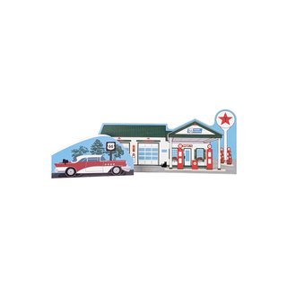 3/4" thick wood Model of a gas station with a car in front on a white background