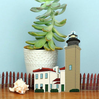 Illustration of a lighthouse, house, and potted plant with 'Beavertail Light' text on a light blue background.