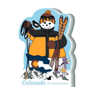 3/4" thick wooden  snowman with skiing gear and Colorado state symbols on a blue background