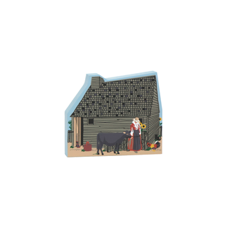 3/4" thick wooden figurine of a woman with a cow in front of a house