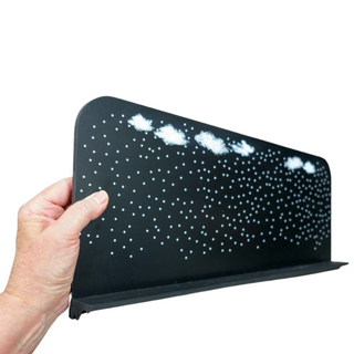 Hand holding a bwall shelf with star and clouds pattern on a white background